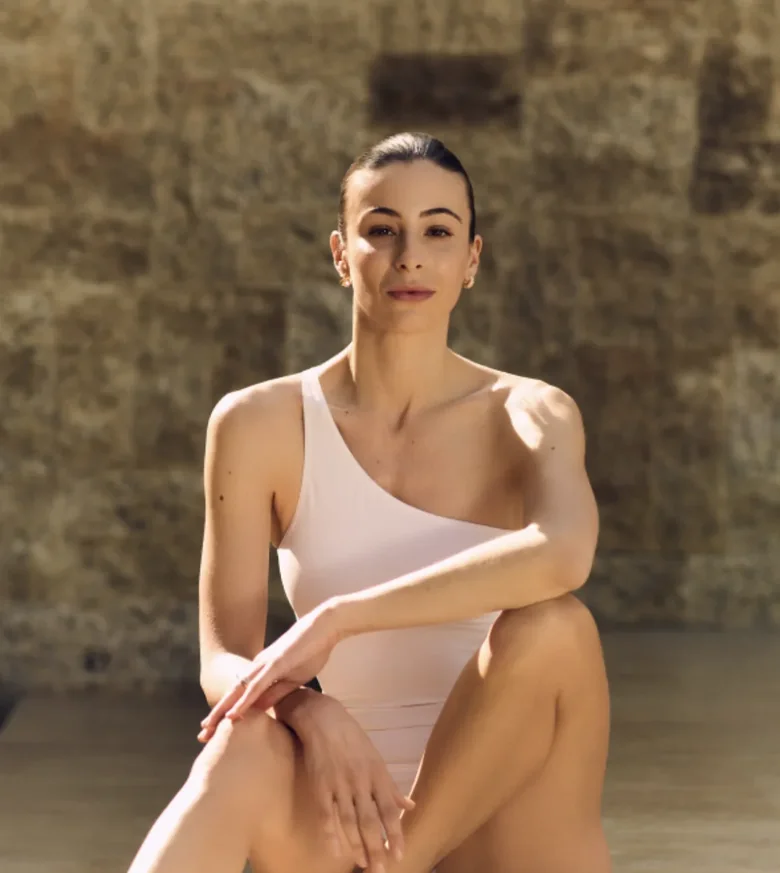 Carlotta in a light one-shoulder top, portrait for a personal newsletter message.