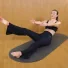 Flat Belly Flow session with Carlotta Gagna leaning back on a mat with one leg raised, the other bent, and arms reaching forward in Pilates Linfodrenante® Express