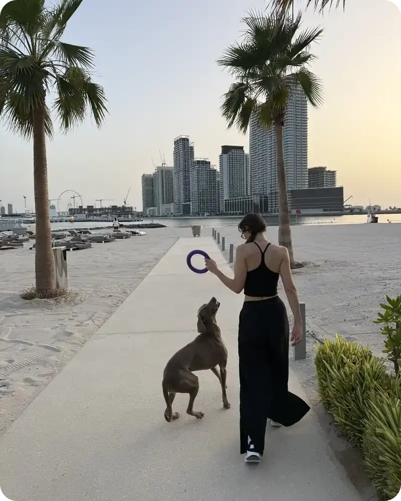 Carlotta Gagna walking along a seaside path with her dog