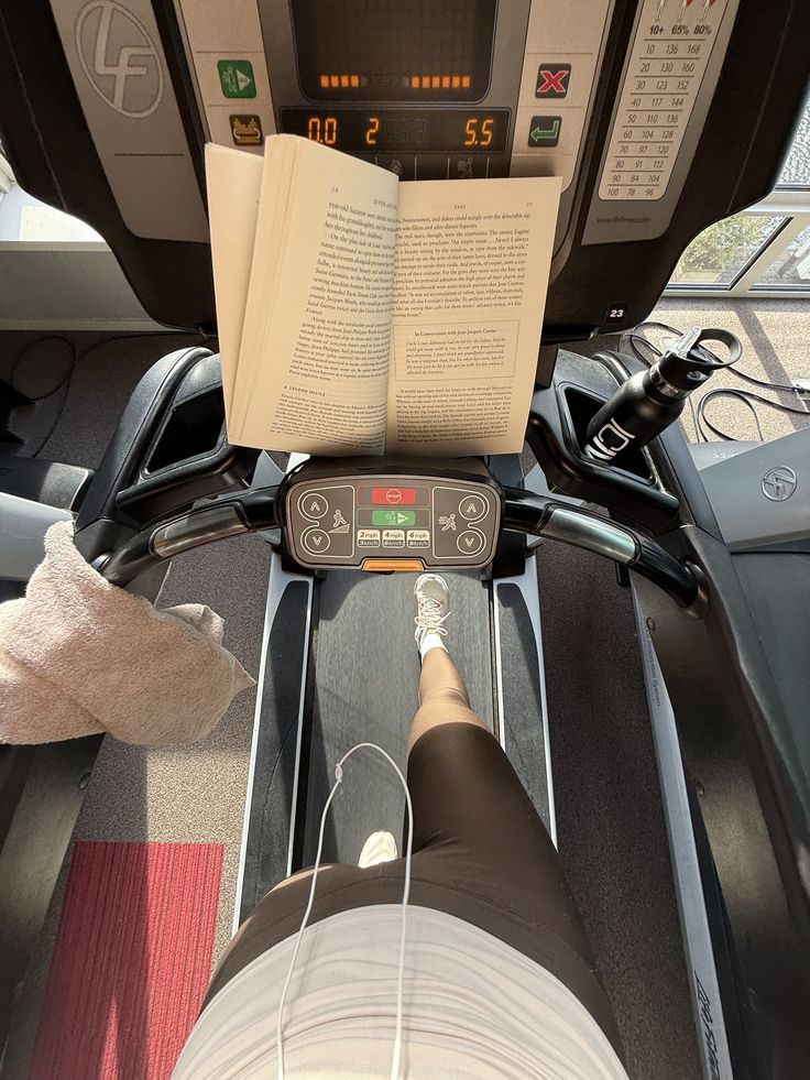 Woman taking a long walk on a treadmill with a book in front of her